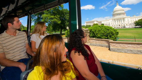 people sightseeing at us capitol building on old town trolley
