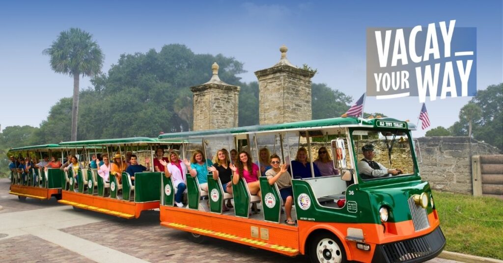 St. Augustine trolley driving past City Gates and Vacay Your Way 