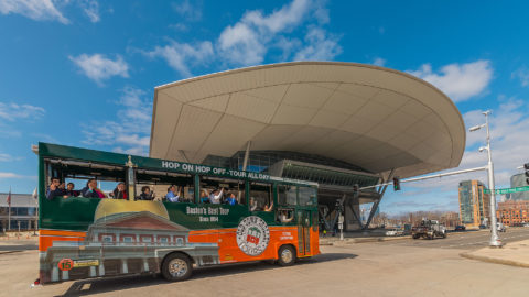 boston old town trolley driving past convention center with a large overhang