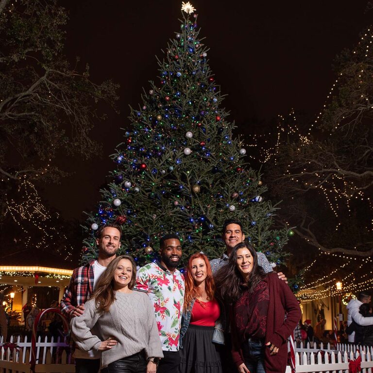 Nights of Lights guests in front of Christmas tree