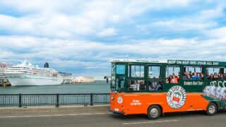 Boston trolley and cruise ship in background