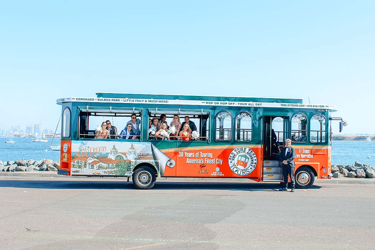 San Diego wedding party and orange and green trolley