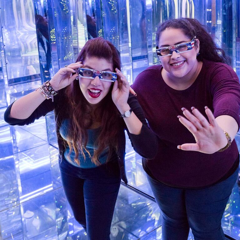 two guests inside mirror maze