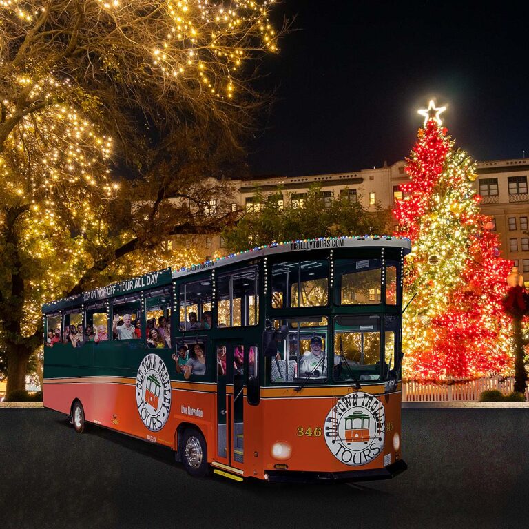 San Antonio holiday trolley surrounded by holiday lights and Christmas tree