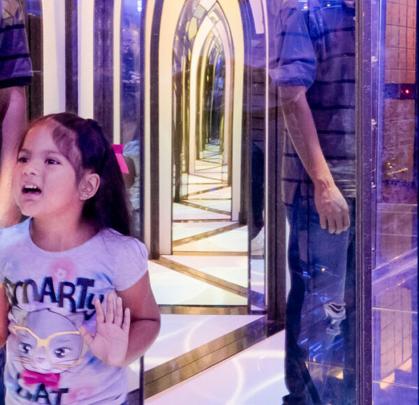 Image on the mirror maze with a family playing